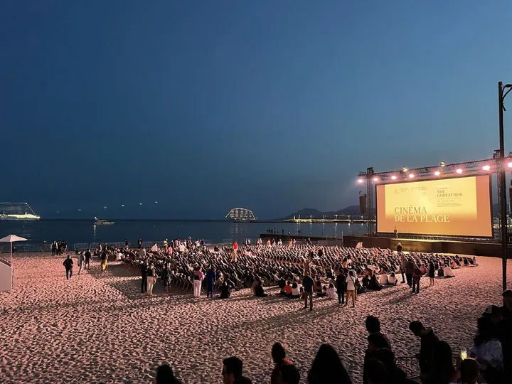 Open-air screening on the beach at night during the Cannes Film Festival